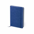 A closed blue fabric-covered notebook with a matching elastic band and bookmark. It has a textured cover and is set against a plain white background, slightly angled to the left.