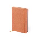A closed, orange fabric-covered notebook with a matching elastic band and ribbon bookmark is standing upright against a white background.