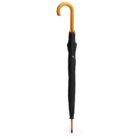 A closed black umbrella with a curved wooden handle stands upright against a plain white background.