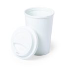 A white, reusable coffee cup with a matching removable lid, placed beside it. The cup and lid are made of a smooth, matte material, and the lid features a sip opening. The cup stands upright while the lid lies flat on the surface.