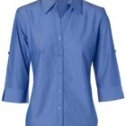 A light blue button-up shirt with a collar and three-quarter sleeves, displayed on a white background.