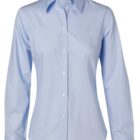 A light blue, long-sleeved, button-up dress shirt with a collar. The shirt is plain with no patterns, featuring white buttons down the front and on the cuffs. It is displayed against a white background.