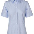 Light blue, short-sleeve, button-up womens shirt with a collar, on a white background.