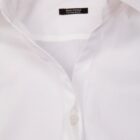 Close-up of a semi-fitted white dress shirt with a visible button and collar.