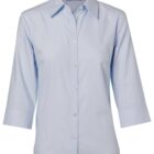 A light blue womens button-up shirt with three-quarter sleeves and a classic collar, displayed on a plain white background.