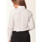 A person with long hair is shown from behind wearing a white button-up shirt and black pants. The shirt has a collar and the sleeves are rolled up slightly. The background is plain and light-colored.