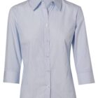 Light blue, collared, long-sleeve button-up shirt with buttons down the front. Tailored fit with smooth fabric texture.