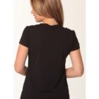 A woman with long, light brown hair is shown from the back, wearing a black t-shirt and facing left.