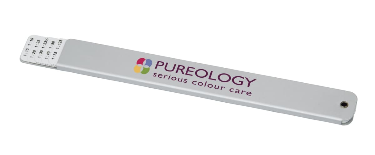 A gray strip with Pureology serious colour care printed on it, featuring a multicolored logo. Theres a small sliding card on one end with numbers listed, resembling a hair color chart.