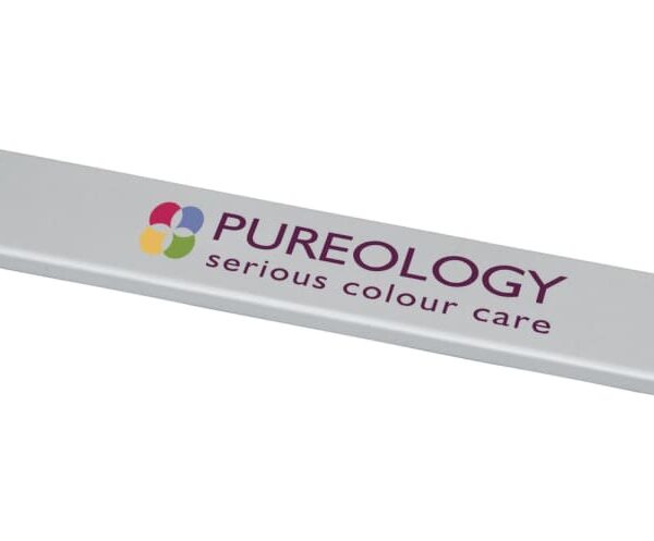 A silver rectangular tool with a small card slider labeled PUREOLOGY serious colour care. The Pureology logo features four colorful overlapping circles.