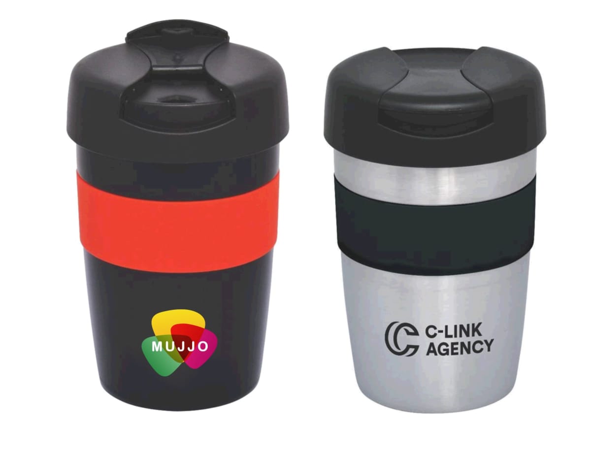 Two reusable coffee cups with lids. The left cup is black with a red band and a colorful logo reading MUJJO. The right cup has a metallic finish with a black band and a logo reading C-LINK AGENCY.