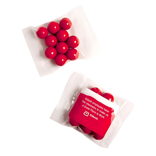 Two small, clear plastic bags containing 25g of red Jaffas each; one bag is open to show the candies, while the other remains sealed with a white-printed message about employees and a Mini Promotional Bags logo.