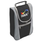 A black and gray zippered travel bag with a handle. It features the Dulux logo on the front, which includes the brand name and a colorful paint splash design.