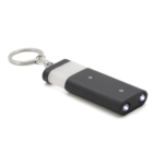 A rectangular black keychain flashlight with dual LED lights on one end and a metal keyring on the other, placed against a white background.