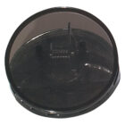 A cylindrical, black plastic lid with a transparent top and an inner rim. It appears to be a cover for a container or appliance part, with a central pin-like protrusion visible through the transparent section.