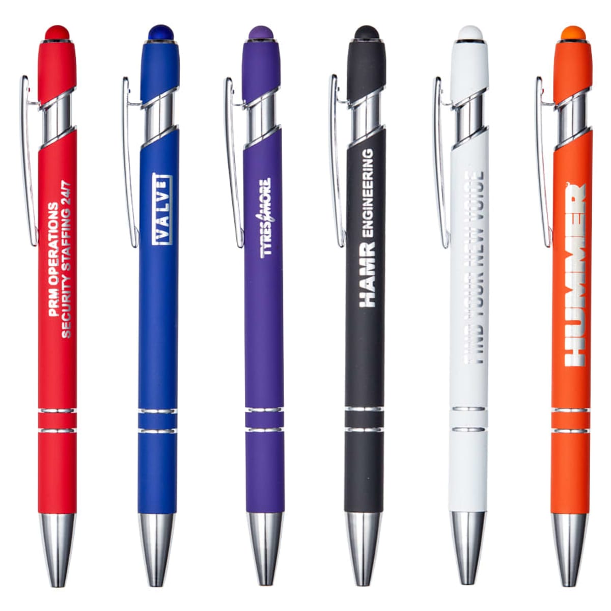 Six colorful ballpoint pens are lined up vertically. Each pen is a different color: red, blue, purple, black, white, and orange. They have silver clips and tips, and each features a printed brand name in white text.