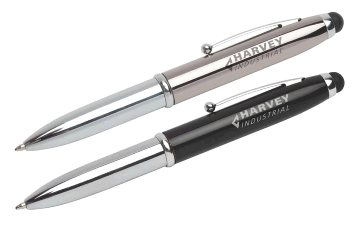 Two metallic ballpoint pens, one silver and one black, lie side by side. Both have HARVEY INDUSTRIAL engraved on their barrels, and feature a stylus tip on the opposite end of the writing point.