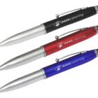 Three ballpoint pens are displayed: one black, one red, and one blue. Each pen features a sleek design with a stylus tip on the end and has the MMcatering logo printed on the side.