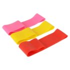 Four resistance bands in pink, yellow, and orange lie flat on a white background. They are small exercise loop bands often used for strength training and physical therapy.