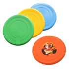 Four colorful frisbees are shown: green, yellow, blue, and orange. The orange frisbee features a playful cartoon face with big eyes, a smiling mouth, and an expressive eyebrow.