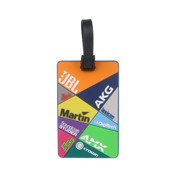 A colorful luggage tag with sections in different colors, each featuring a logo: JBL, Martin, Soundcraft Studer, AKG, Lexicon, DigiTech, AMX, and Crown. The tag has a black strap attached for securing to luggage.