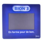 A blue rectangular object with a central screen and the text BION 3 on top. Below the screen, it reads En forme pour de bon. The brand logo MERCK is in the bottom right corner.