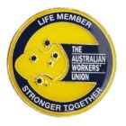 The image shows a circular badge with yellow and black colors, featuring a map of Australia with stars. Text reads Life Member at the top, The Australian Workers Union in the center, and Stronger Together at the bottom.