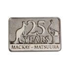 Silver rectangular pin featuring a kangaroo and an emu flanking the text 25 YEARS. Below, it reads MACKAY - MATSUURA.