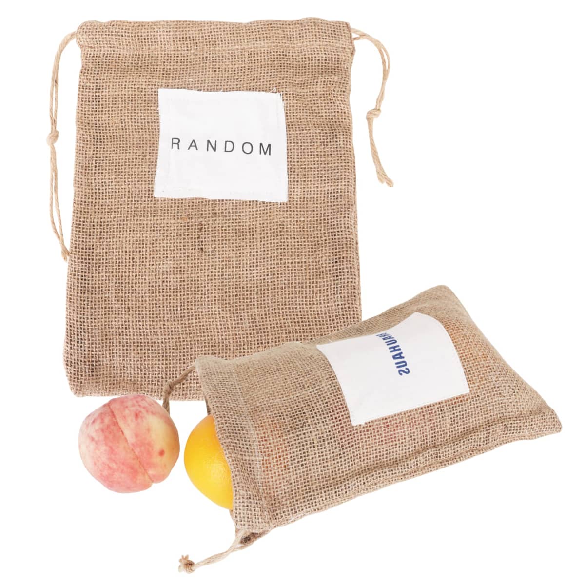 Two burlap bags with drawstrings, one upright labeled RANDOM and the other lying down. Two fruits, resembling a peach and an orange, are partially visible emerging from the lying bag.