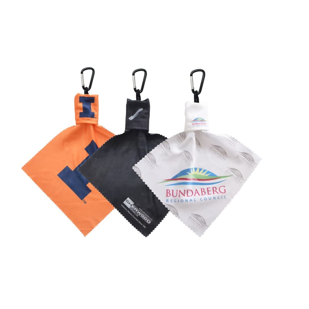 Three microfiber cloths, each with a clip at the top. The cloths are orange, black, and white, featuring different printed logos and designs, including Bundaberg Regional Council. They are arranged side by side.