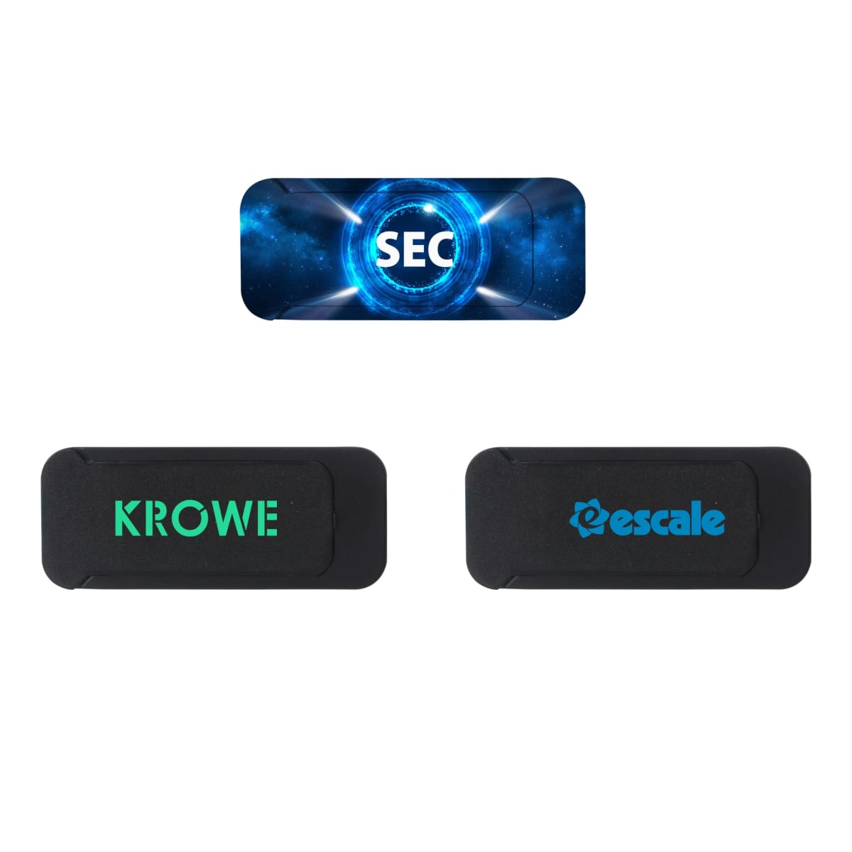 Three rectangular webcam covers are displayed. The top cover features SEC with a blue futuristic design. The bottom two covers are black, with the left one labeled KROWE in green and the right one labeled escale in blue.