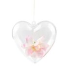 A clear heart-shaped ornament with pink and white flowers inside, hanging by a thin string. The transparent design showcases the delicate petals, giving it an elegant and romantic appearance.