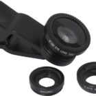 A black clip-on camera lens with a fisheye attachment is displayed alongside two additional lenses labeled MACRO and 0.67X WIDE, used for smartphone photography.