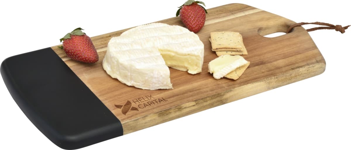 Wooden cheese board with a wheel of brie, two strawberry halves, and crackers. The board has a black handle edge and a Helix Capital logo.