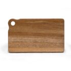 A rectangular wooden cutting board with a smooth surface and a hole in the upper left corner for hanging. The wood grain is visible, showing natural patterns and texture. The board rests on a white background.