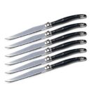 A set of six serrated steak knives with black handles arranged parallel to each other against a white background.