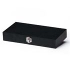 A black rectangular box with a textured surface is closed with a metal latch at the front. It is placed against a plain white background.