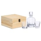 A wooden box next to a crystal decanter with a stopper and two matching whiskey glasses on a white background.