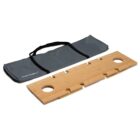 A foldable wooden picnic table with cup holders, laid flat next to a grey carrying bag. The table has cutouts on the sides for assembly.