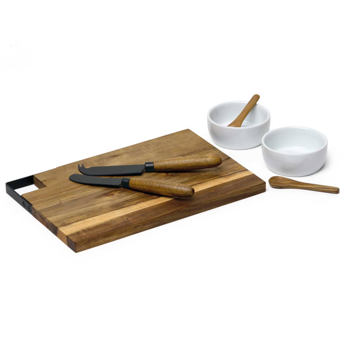 A wooden cutting board with two cheese knives resting on it. Nearby, there are two small white bowls, each with a matching wooden spoon. The background is white and minimalist.