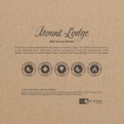 Brown cardboard packaging for Mount Lodge 100% Merino Blanket. Features text describing the soft and warm qualities, a vintage design, care instructions, and eco-friendly icons, including wool mark, softness, warmth, durability, and a heart symbol.