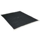 A dark-colored rug with a small central hole and white fringed edges, spread out on a plain background.