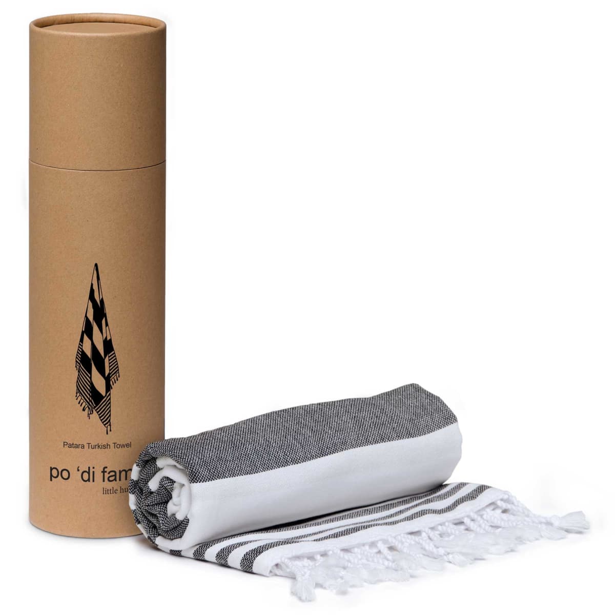 A black and white fringed Turkish towel, rolled up, sits next to a cylindrical cardboard container labeled po di fantasia with a graphic of a towel on it.