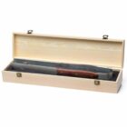 A large stainless steel bottle opener with a wooden handle is displayed inside an open wooden box. The box has metal hinges and a soft black lining, designed to securely hold the opener.