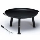A large, black metal fire pit with three sturdy legs and two side handles. It is accompanied by a long metal poker for adjusting logs or coals. The fire pit has a wide, shallow bowl design suitable for outdoor use.