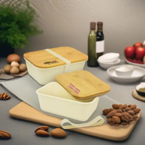 Two lunch boxes on a table with nuts and plates