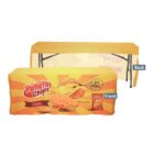 A promotional table cover with a potato chips theme. The front displays images of cheese-flavored chips and a 100% Natural label, on a yellow and orange background. The back is plain yellow.