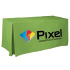 A rectangular table covered with a green cloth featuring the logo of Pixel Marketing Solutions. The logo includes a colorful geometric shape next to the company name in bold black letters.