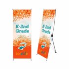 Two standing banners display K-2nd Grade with a colorful geometric background. They feature an arrow and the logo kidz life at the bottom against an orange backdrop. The banners are supported by metal stands.