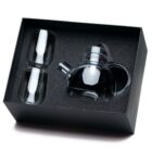 A black box containing a clear glass teapot with a lid and two double-walled glass cups, nestled in foam padding.